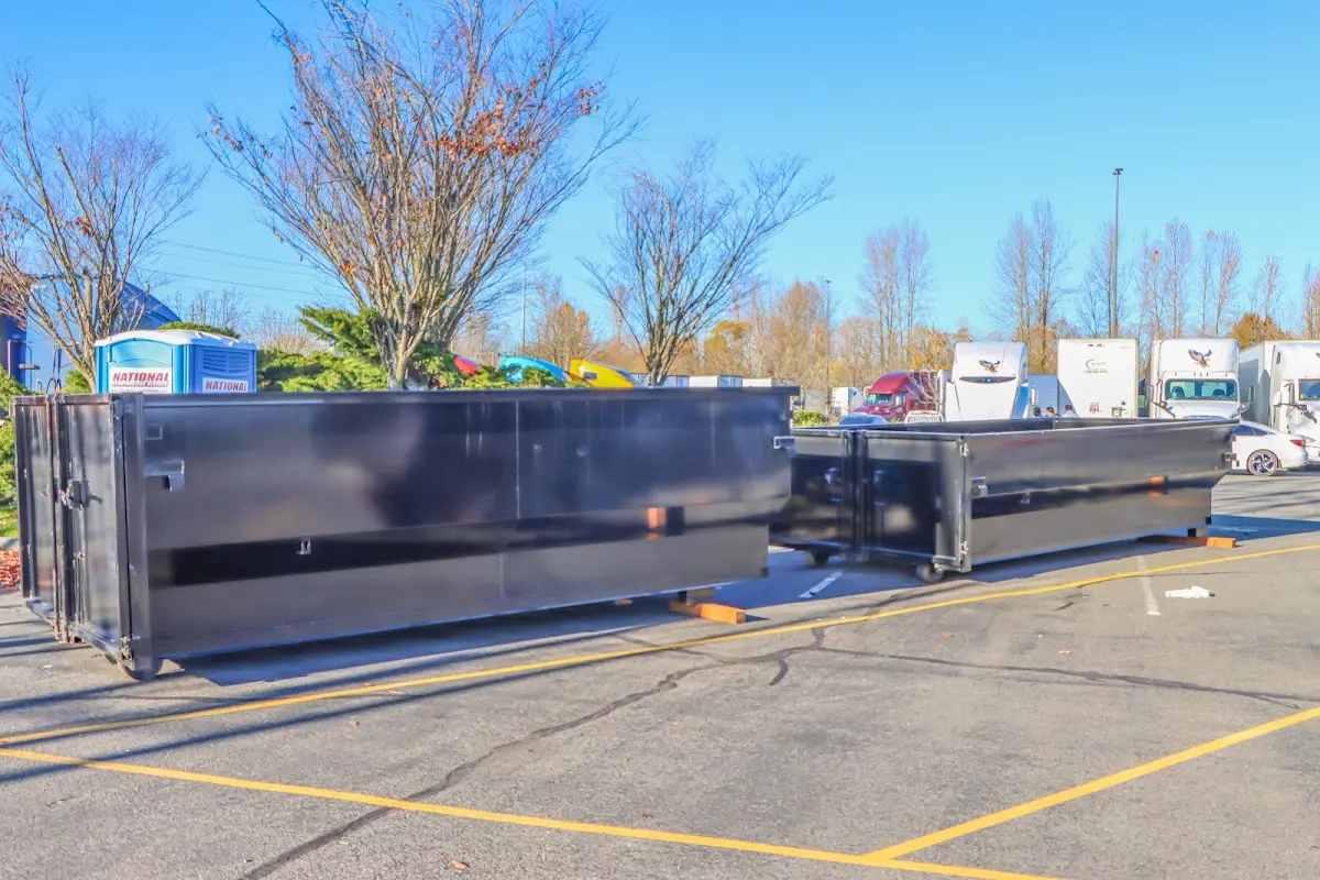 Professional dumpster rental service with roll-off container on residential driveway in Broadalbin